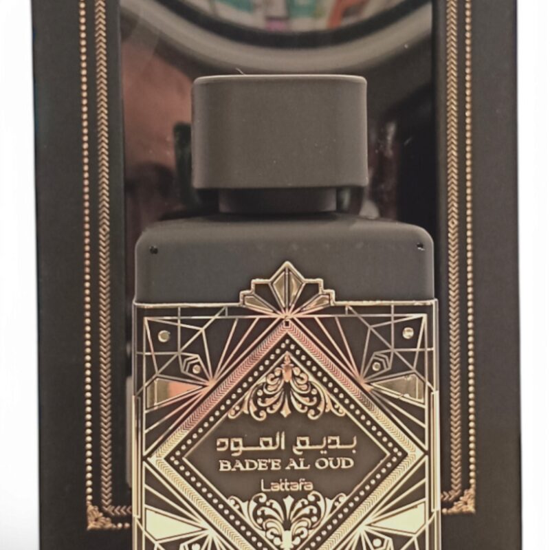 El frasco negro de Lattafa Asad Zanzibar EDP 100 ml se encuentra delante de su caja negra y dorada decorada con motivos geométricos y árabes.