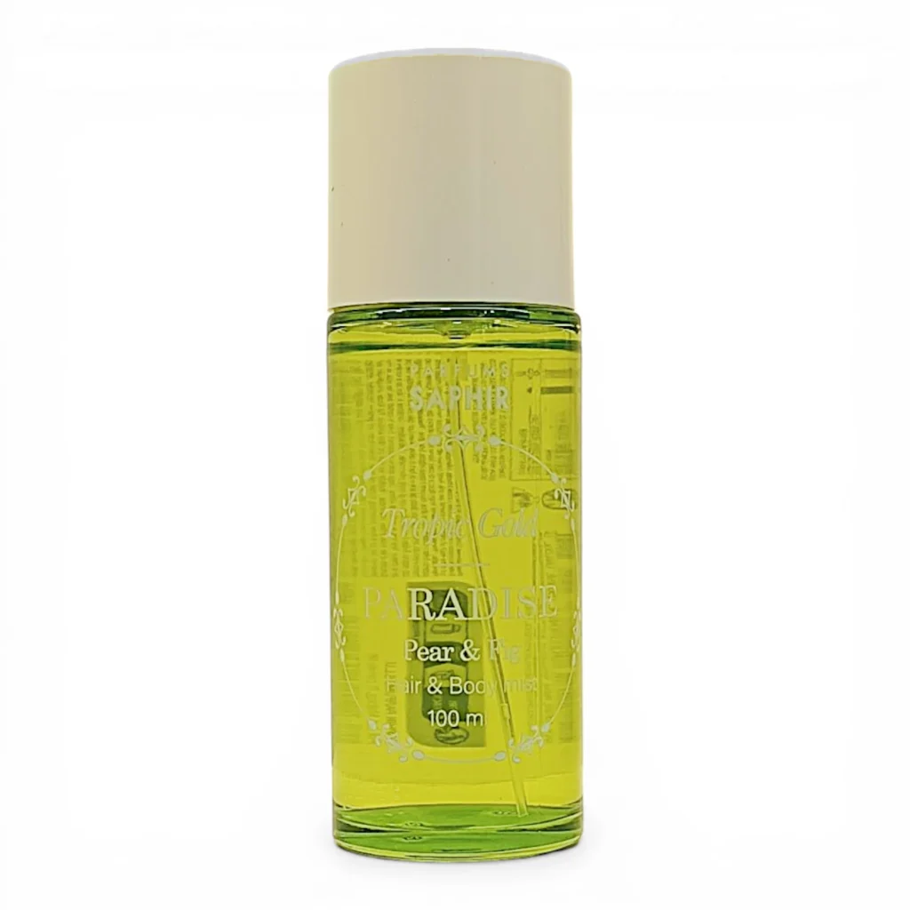 Frasco transparente de perfume Saphir Paradise Tropic Gold, lleno de líquido amarillo verdoso, con tapón blanco y etiquetado como Pear & Fig, Hair & Body Mist, 100 ml.