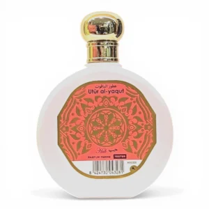Un frasco redondo de perfume blanco con tapón dorado y una etiqueta decorativa roja y dorada en la que se lee Utûr al-yaqût en árabe e inglés, junto con un código de barras y las palabras Parfum Femme Tester en la parte inferior.